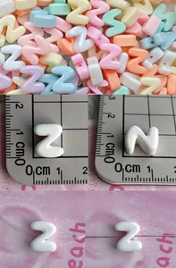 Macro view of 12mm macaron color acrylic letter beads with horizontal holes for DIY jewelry