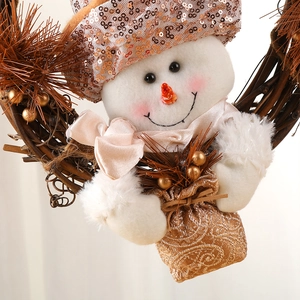 Christmas snowman wreath with sequined hat and golden accents on natural rattan base
