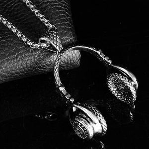 Polished silver headphones pendant necklace in stainless steel on a sleek black background