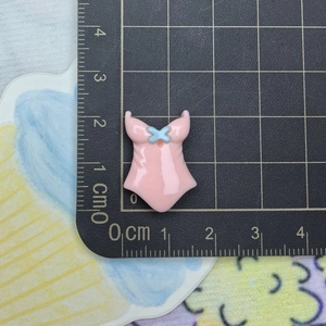 Pink swimsuit resin accessory charm for crafts with 2.5cm measurement on ruler