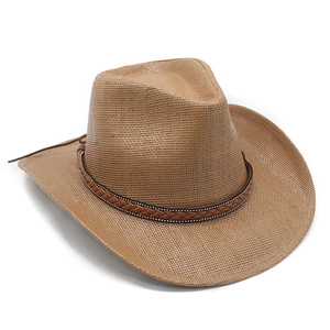 Detail of classic brown straw cowboy hat with wide brim and leather braided band