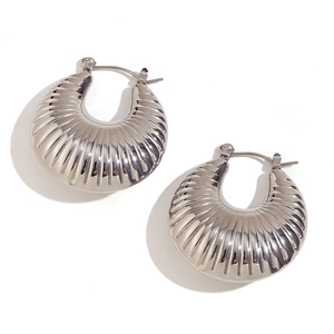 Chic silver hollow shell horn earrings with textured radial stripes on a white background