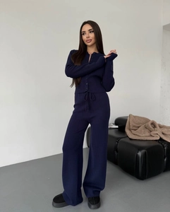 Detail of dark blue knit lounge set featuring a buttoned cardigan and high-waist pants