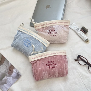 Detail of velvet makeup bags with heart embroidery and Shine Like the Stars text