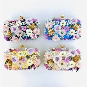Detailed view of four colorful handmade evening clutch bags with 3D sequin flowers