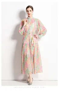 Detail of floral patchwork dress with mandarin collar and woven tassel belt