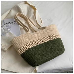 Close-up of woven tote bag texture with off-white and green wave patterns on fabric