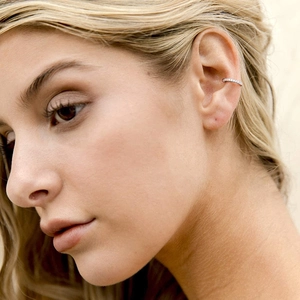 Fashion S925 sterling silver ear cuff with white zircon stones on model's ear