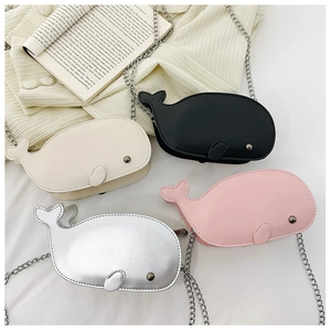 Macro detail of whale-shaped crossbody bags in faux leather with metal chains