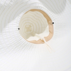 Detail of white sun hat interior with inner drawstring and adjustable sweatband