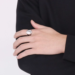 Detailed close-up of a men's stainless steel ring featuring irregular crack patterns