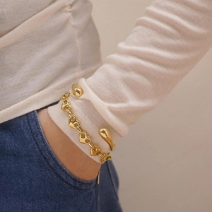 Elegant 18k gold-plated stainless steel heart bracelet and teardrop cuff on female model