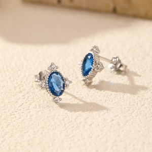Vintage S925 silver stud earrings with oval blue gem and star halo decoration