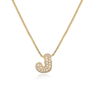 Detailed view of golden bubble letter J pendant with shimmering cubic zirconia settings