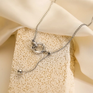 Silver interlocking ring lariat necklace with zircon pavé and ball charm on stone