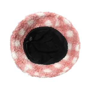 Close-up of pink lamb wool bucket hat with white polka dots showing the inner lining