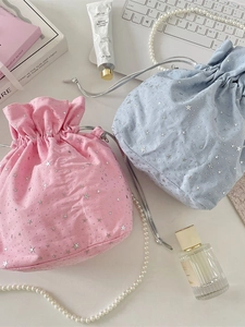 Pink and blue canvas drawstring bags with silver star print in an elegant lifestyle setting