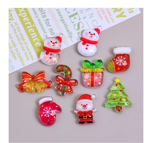 Flat lay macro of colorful glitter resin Christmas charms like Santa and Snowman