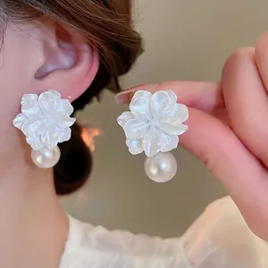 Elegant silver needle flower earrings with white resin petals and large pearl drop pendants