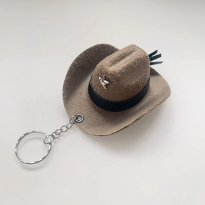 Brown cowboy hat keychain with a silver star charm and metallic ring shown from a 45-degree angle