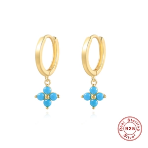 Detail of 925 sterling silver hoop earrings with blue clover charm in gold finish