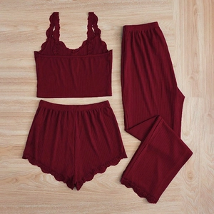 Close-up of deep wine red ribbed knit pajamas with delicate lace trim on hem and waist