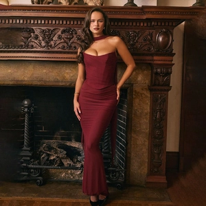 Detail of the back of a slim-fit wine red evening gown with a draped back design