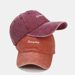 Close-up of vintage washed cotton baseball caps with Everyday cursive embroidery detail