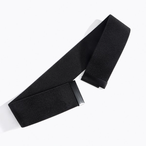 Detail of a 5cm wide black elastic waist belt with a sleek matte rectangular buckle