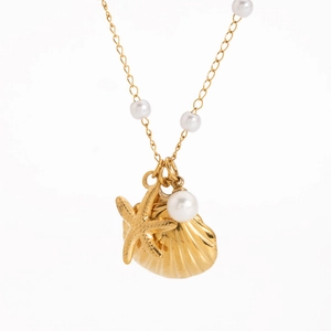Detailed close-up of a gold necklace featuring pearl, starfish, and shell pendants