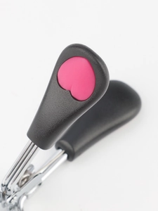 Detailed macro view of the matte black handle featuring a pink heart on a lash curler