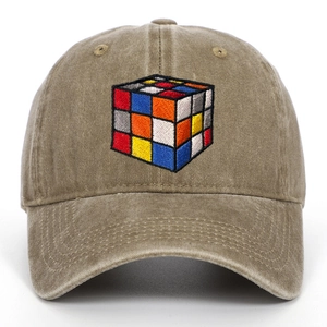Close-up of the vintage washed khaki cotton cap with colorful Rubik's Cube embroidery
