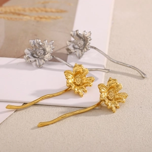 Detail of vintage flower stud earrings with long stems in gold and silver finish