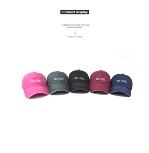 Five colors of washed denim baseball caps featuring DOGS > PEOPLE embroidered slogans