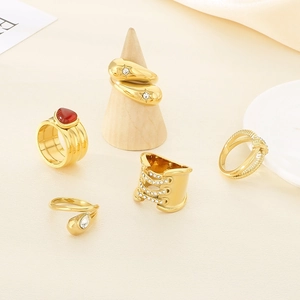 Set of 5 18K gold plated rings featuring star patterns, red gemstone, and snake design