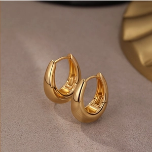 S925 gold-plated U-shaped hoop earrings with a polished finish on a beige textured background