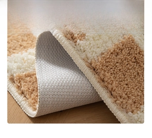Detailed macro view of non-slip TPR backing and high-quality stitched edges on tufted rug