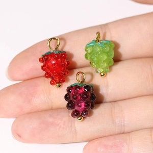 Handmade fruit-shaped glass charms in red and green with metallic hanging loops
