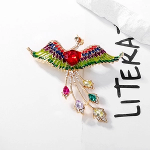 Exquisite phoenix brooch with multicolor enamel wings and a red heart-shaped gemstone