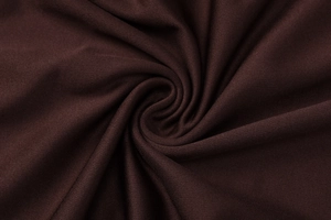 Macro texture du tissu tricoté marron foncé montrant les points fins et la matière de qualité