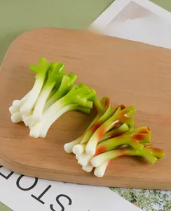 Detailed macro view of realistic faux green onions on a wooden cutting board