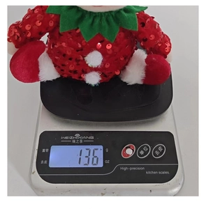 Weight measurement of cute plush strawberry doll with red sequins weighing 136g