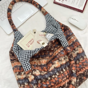 Detail of plush tote bag showing inner gingham lining and metal magnetic closure