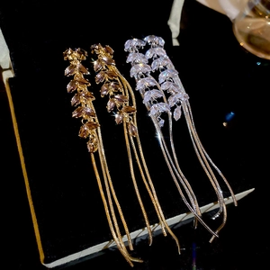 Macro shot of long fringe earrings with marquise crystals on black velvet display