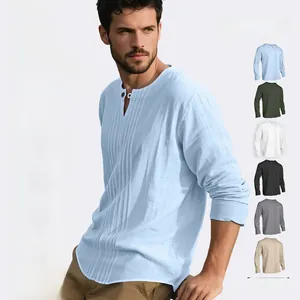 Close-up detail of a men's linen henley shirt showing fabric texture and pleated chest design