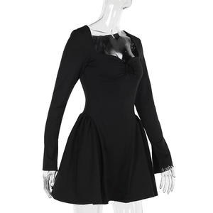 Detail of sweetheart neckline and drawstring pleats on a black long sleeve dress
