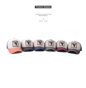 Group display of six distressed baseball caps with eagle patches and breathable mesh backs