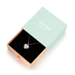 Detail of drawer-style jewelry box with heart pendant necklace and Te Amo Mama engraving