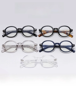 Detail view of round vintage glasses in black, tortoiseshell, and transparent frames