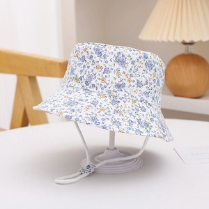 Detail of floral baby sun hat with blue flowers, chin strap, and adjustable cord buckle